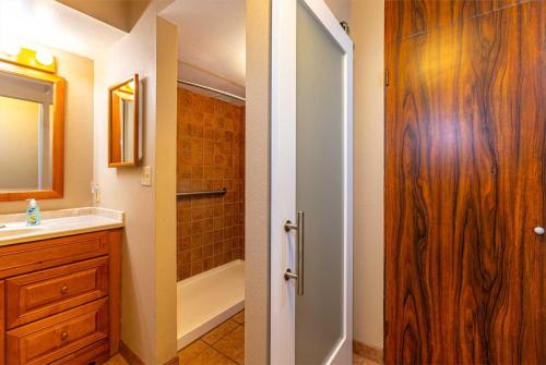 a bathroom with a shower and a sink and a toilet at Kihei Akahi Resort - Unit D114 in Wailea