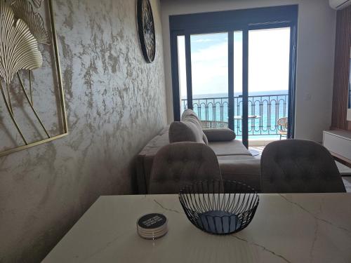 a living room with a couch and a table at Vienna Luxury Apartments in Dobra Voda