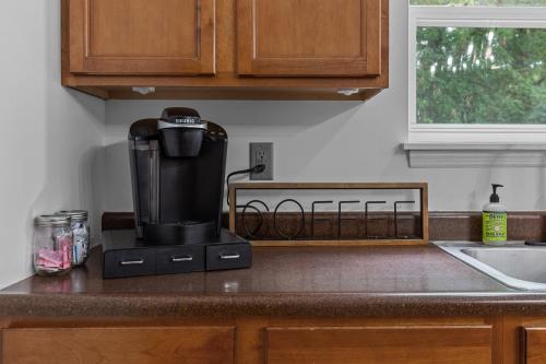 a coffee maker sitting on a counter in a kitchen at Springhurst Serenity Fresh 4BR Getaway in O'Fallon
