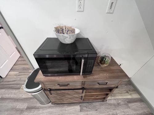 a microwave sitting on top of a wooden table at Springhurst Serenity Fresh 4BR Getaway in O'Fallon