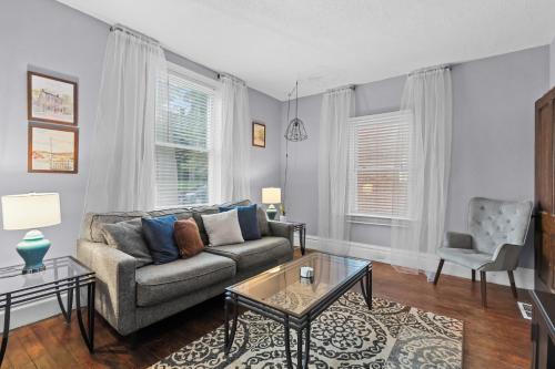 a living room with a couch and a table at Historic 2 bedroom house St Charles in St. Charles