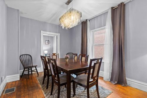 a dining room with a wooden table and chairs at Historic 2 bedroom house St Charles in St. Charles
