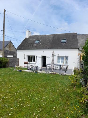 a white house with a yard in front of it at Chez Tinou in Bacilly