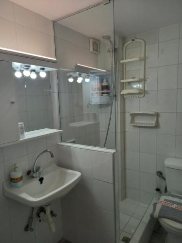 a bathroom with a sink and a shower and a toilet at Korasida Blue Coast in Akhladherí