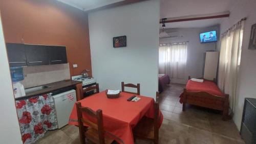 a kitchen with a table with a red table cloth on it at La Nilda in Tandil