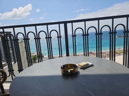 a table on a balcony with a view of the beach at Vienna Luxury Apartments in Dobra Voda