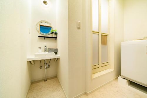 a bathroom with a sink and a mirror at 63, Shiomi, First floor of the apartment, 潮見1F in Tokyo