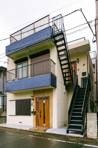 a building with a staircase on the side of it at 63, Shiomi, First floor of the apartment, 潮見1F in Tokyo