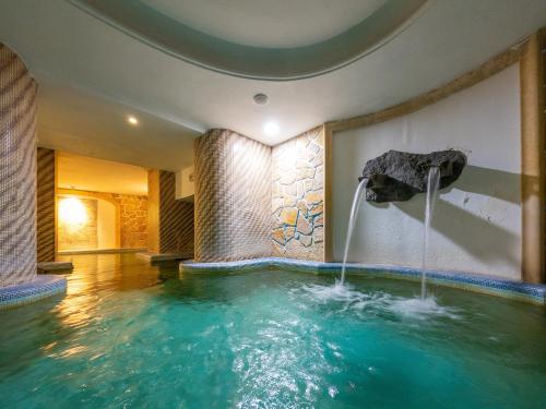 a pool in a hotel with a water fountain at Av Isola Verde Hotel Thermal Spa in Ischia