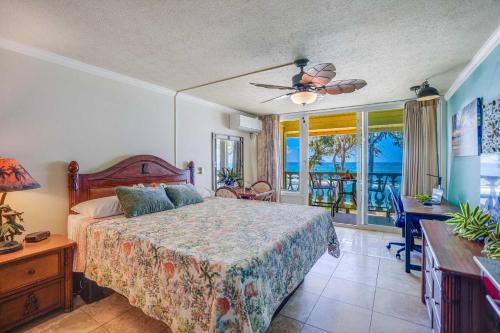 a bedroom with a bed and a view of the ocean at Islander on the Beach 328 in Kapaa