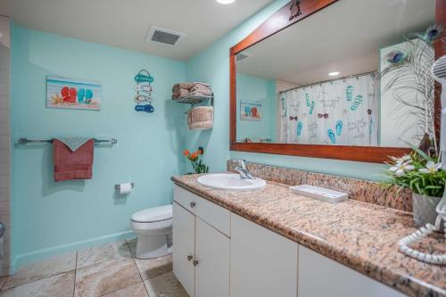 a bathroom with a sink and a toilet at Islander on the Beach 328 in Kapaa