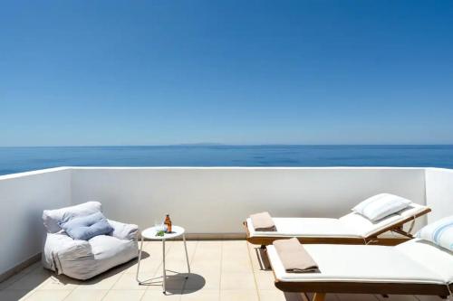 a balcony with chairs and a view of the ocean at Villa Alia in Sfakiá
