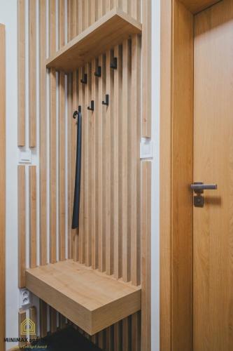 a wooden cabinet with a black tie on it at MINIMAX apartmán in Deštné v Orlických horách
