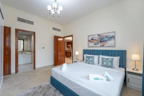 a bedroom with a large white bed in a room at Peaceful flat in Motor City in Dubai