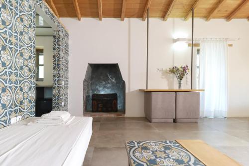 a living room with a fireplace and a bed at Just Barrett in Rovies