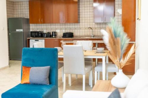 a kitchen with a table and chairs in a kitchen at Peaceful flat in Motor City in Dubai