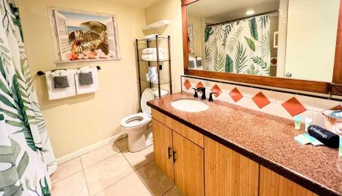 a bathroom with a sink and a toilet and a mirror at Islander on the Beach 152 in Kapaa