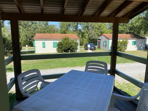 a blue table and chairs on a porch at Camping maeva Respire de La Croze in Châtel-Guyon