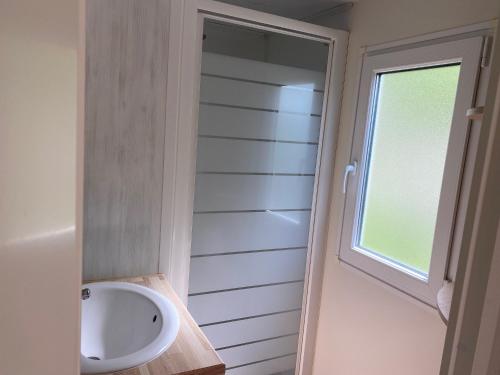 a small bathroom with a sink and a window at Camping maeva Respire de La Croze in Châtel-Guyon