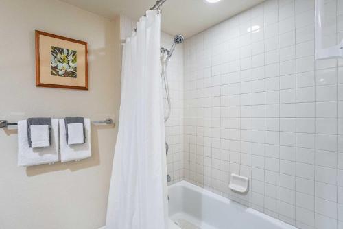 a white bathroom with a tub and a shower at Islander on the Beach 363 in Kapaa