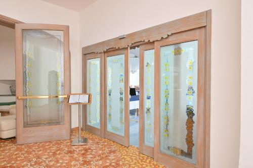 a row of glass doors in a room at Av Isola Verde Hotel Thermal Spa in Ischia