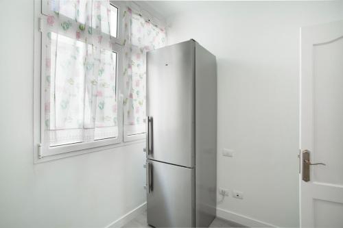 a refrigerator in a kitchen with two windows at El Rincón de Mónica in Agaete