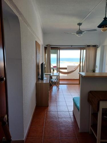 a living room with a view of the ocean at Espectacular en primera línea de playa in Costa da Caparica