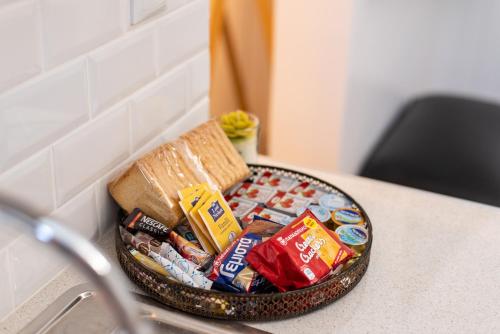 a bowl of food on a counter with a sandwich and other snacks at Eden - A Night near Athens Int Arpt in Spáta