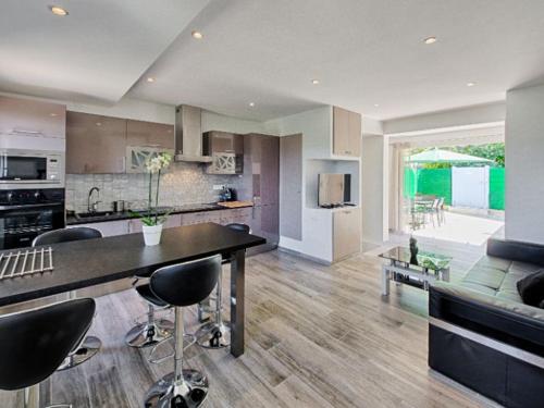 une cuisine et un salon avec une table et des chaises dans l'établissement Maison Cogolin Panorama du Golf, à Cogolin