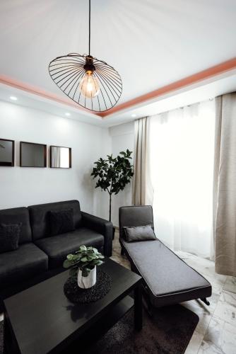 a living room with a couch and a table at Prestige Lumineux Jacuzzi Parking privé in Mulhouse