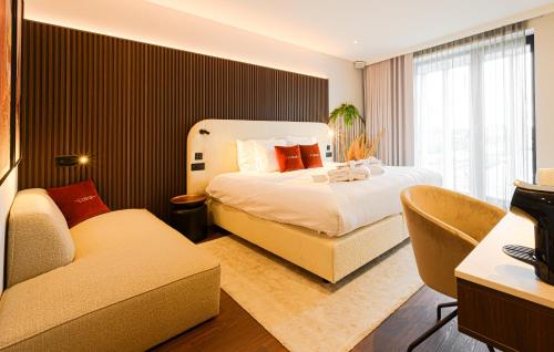 a hotel room with a bed and a couch at The CORNR Hotel in Nieuwpoort