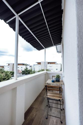 a balcony with a table and a view of the city at Prestige Lumineux Jacuzzi Parking privé in Mulhouse