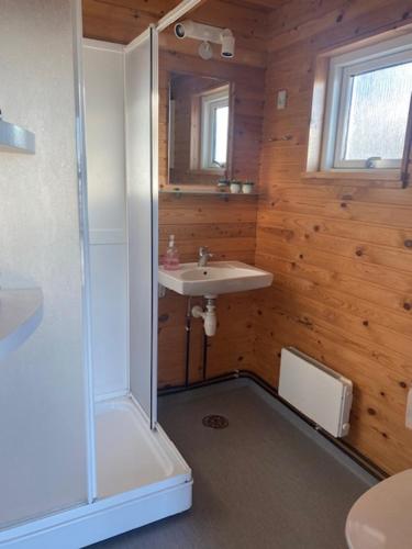 a bathroom with a shower and a sink at Løkken Klit Camping & Cottage Village in Løkken