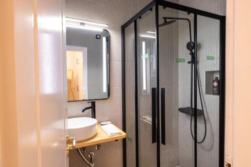 a bathroom with a sink and a shower at Eden - A Night near Athens Int Arpt in Spáta