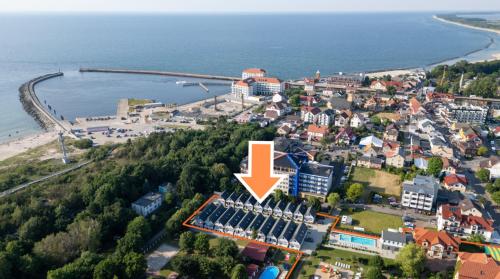 an aerial view of a town next to the water at Domki OLIVIA in Darlowko