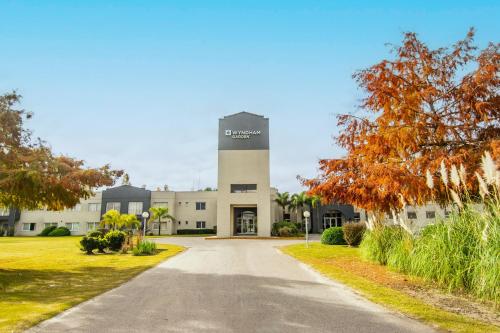 a building with a clock tower in the middle of a road at Wyndham Garden Campana in Campana
