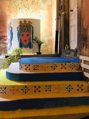 a set of steps leading to a door with a painting at L'Alloggio dell'Artista in Belpasso