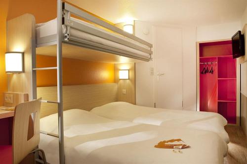 a hotel room with two bunk beds in it at Premiere Classe Pau Est-Bizanos in Pau