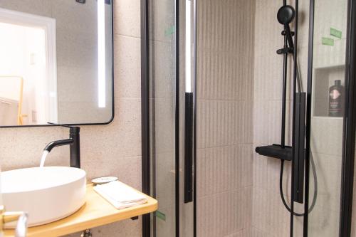 a bathroom with a sink and a shower at Eden - A Night near Athens Int Arpt in Spáta