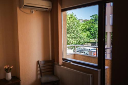a window in a room with a view of a balcony at Семеен хотел Свети Георги in Sandanski
