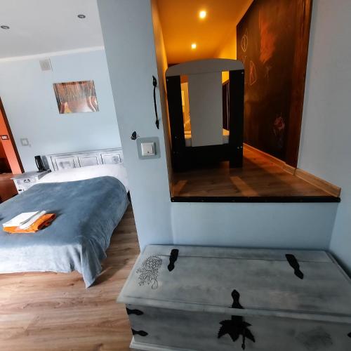 a small bedroom with a bed and a mirror at Gościna U kowala in Lachowice