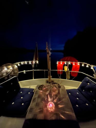 a table on a boat with a candle on it at Yachthouse in Plateliai