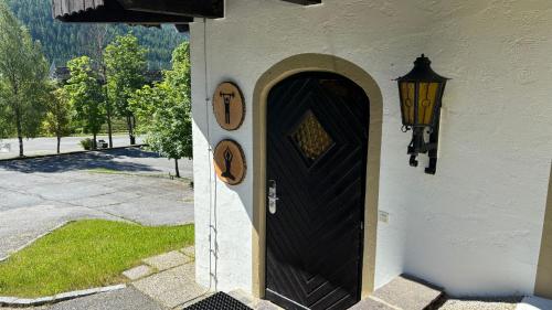 a doorway to a house with a black door at MountainView Lodge - Am Fuße der Gondel und Skipiste in Sankt Oswald