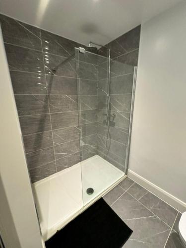 a shower with a glass door in a bathroom at Beach Front in Clacton-on-Sea