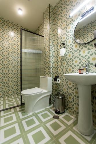 a bathroom with a toilet and a sink at Boutique Hotel Tuta in Kutaisi