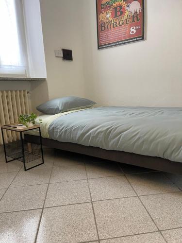 a bed in a room with a side table at Private Loft La Rocchetta, Lake Maggiore in Angera