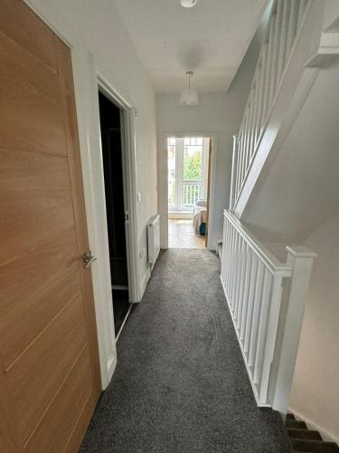 an empty hallway with a staircase in a house at Beach Front in Clacton-on-Sea