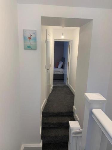 a hallway with a staircase leading to a bedroom at 19 Eyre Square Lane Galway in Galway