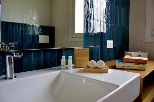 a bathroom with a white sink and a mirror at Villa Casa Madre in San Vito lo Capo