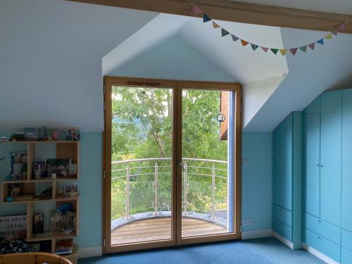 a room with a large window and a balcony at Poulou Pyrénées in Gelos